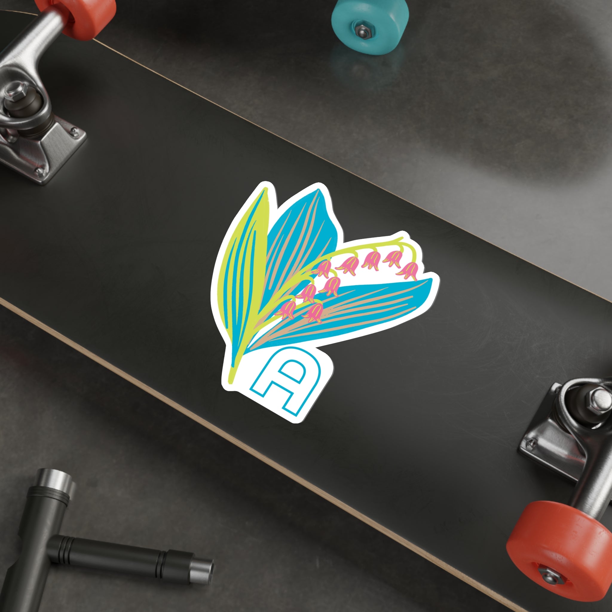 May birthday flower sticker on the underside of a skateboard